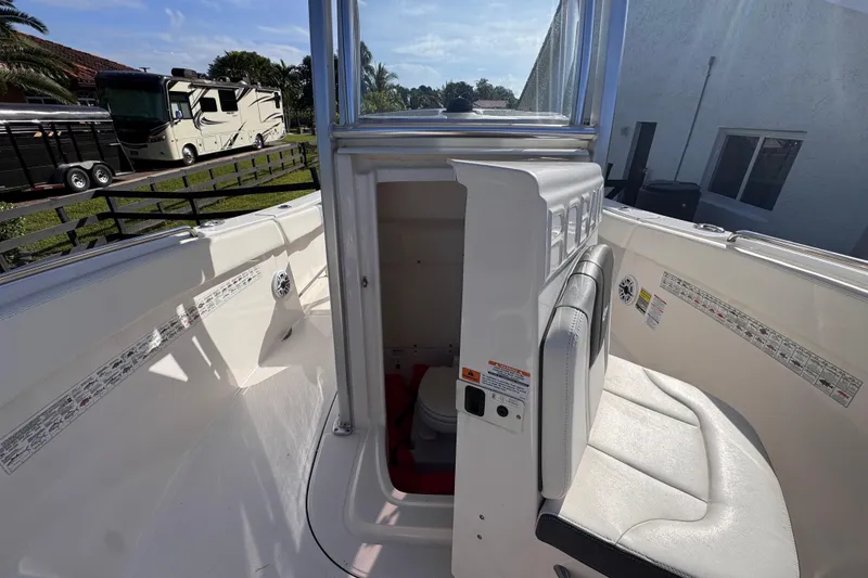 Slide: The Image of 2022 Robalo R230 Center Console boat interior with seating and storage compartment. - 31