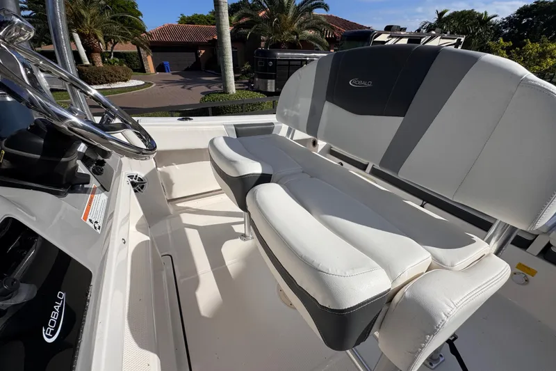 Slide: The Image of 2022 Robalo R230 Center Console boat interior with steering wheel and seating. - 35