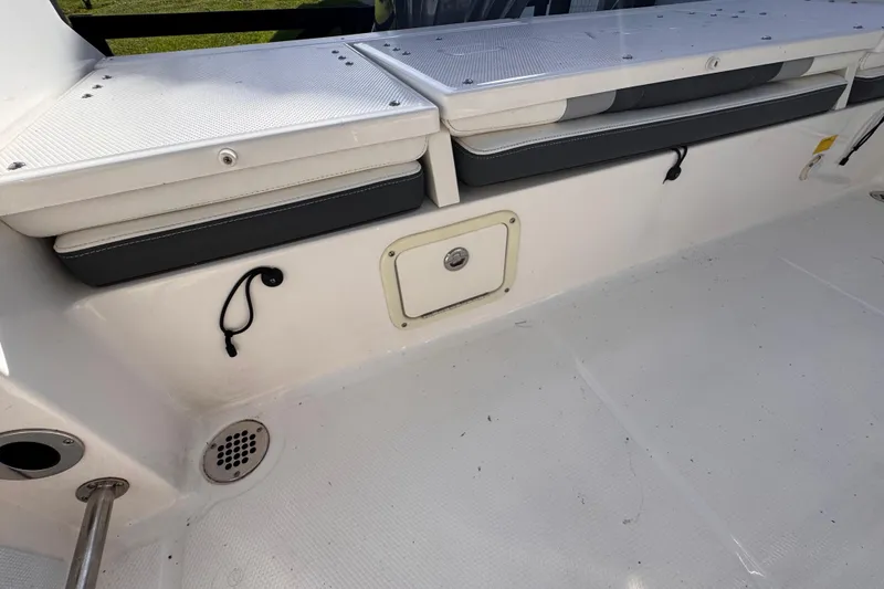Slide: The Image of 2022 Robalo R230 Center Console boat interior with seating and storage compartments. - 38