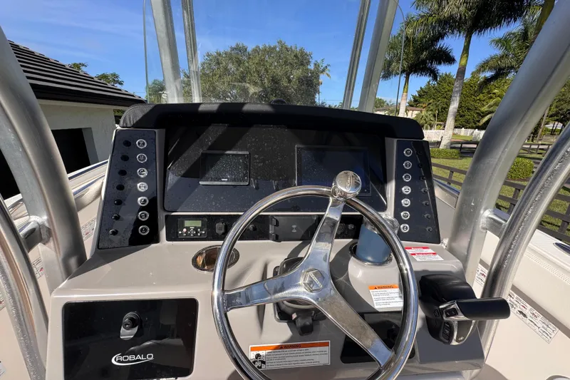 Slide: The Image of 2022 Robalo R230 Center Console dashboard with steering wheel and controls. - 41