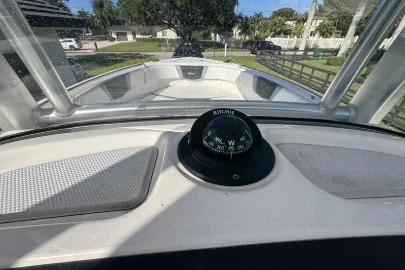 Slide: The Image of 2022 Robalo R230 Center Console boat with compass, viewed from helm. - 42