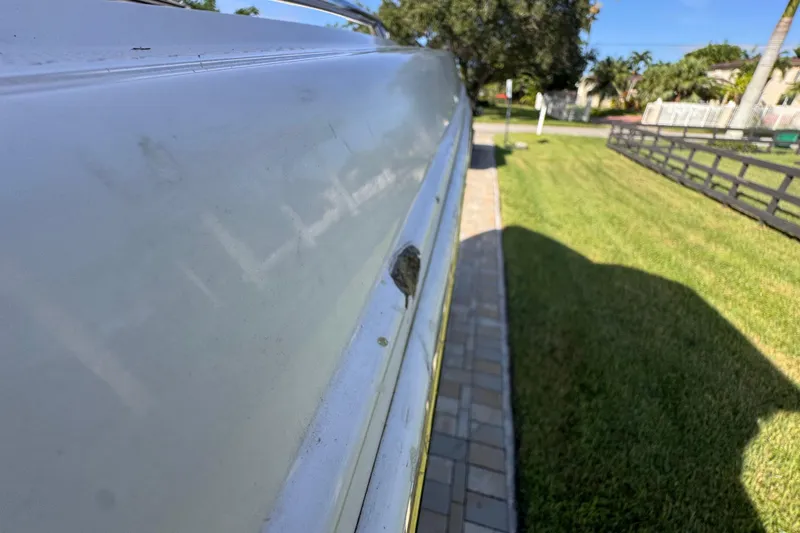 Slide: The Image of Side view of 2022 Robalo R230 Center Console boat on a sunny day. - 44