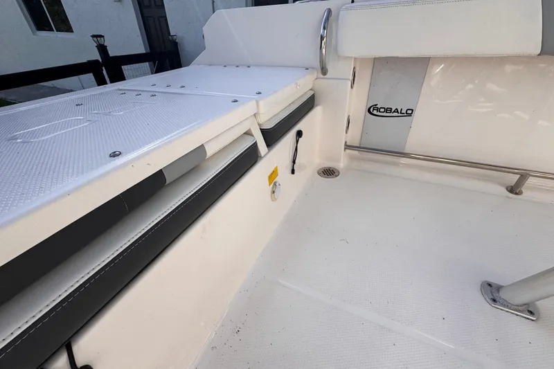 Slide: The Image of 2022 Robalo R230 Center Console boat interior, featuring seating and storage area. - 46