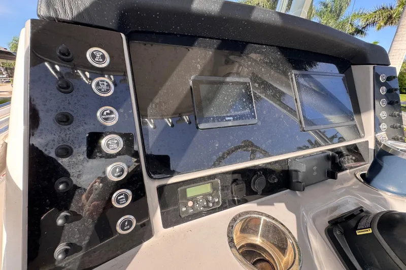 Slide: The Image of 2022 Robalo R230 Center Console dashboard with controls and dual displays. - 49