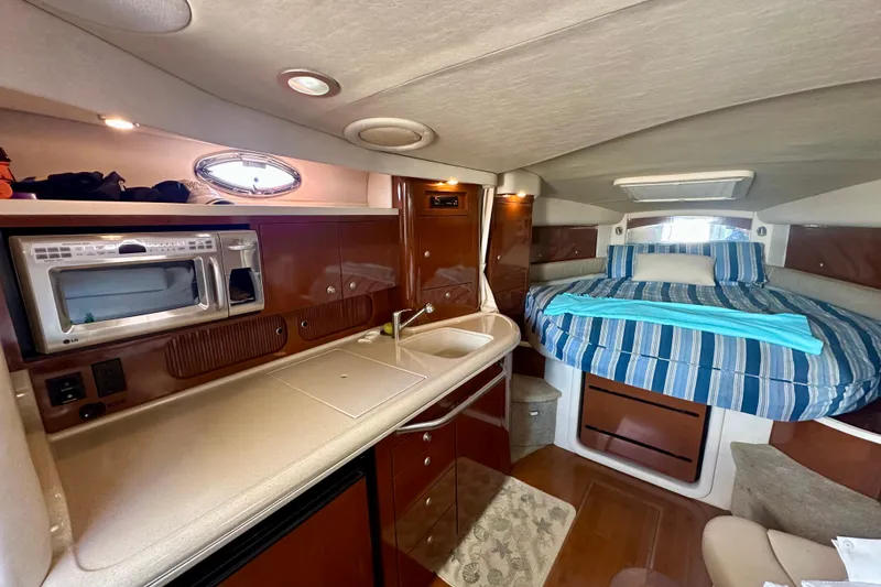 Slide: The Image of Interior of 2008 Sea Ray 340 Sundancer with kitchenette and cozy sleeping area. - 10