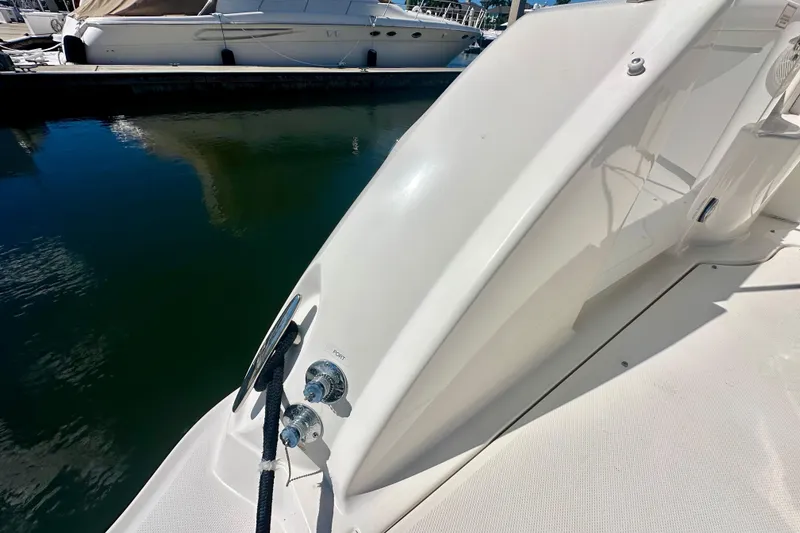 Slide: The Image of 2008 Sea Ray 340 Sundancer yacht docked, showing sleek white exterior and water reflection. - 4