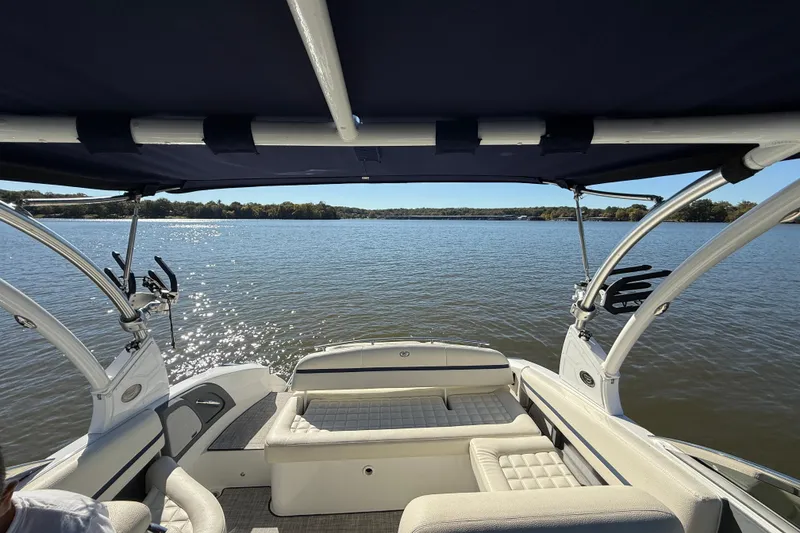 Slide: The Image of 2018 Cobalt R3 Surf boat on a serene lake under a blue canopy. - 13