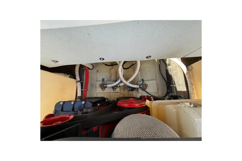 Slide: The Image of Engine compartment of a 2018 Cobalt R3 Surf boat, showing hoses and components. - 4