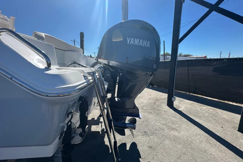 Slide: The Image of 2024 Sea Hunt Ultra 219 boat with Yamaha outboard motor in sunlight. - 100
