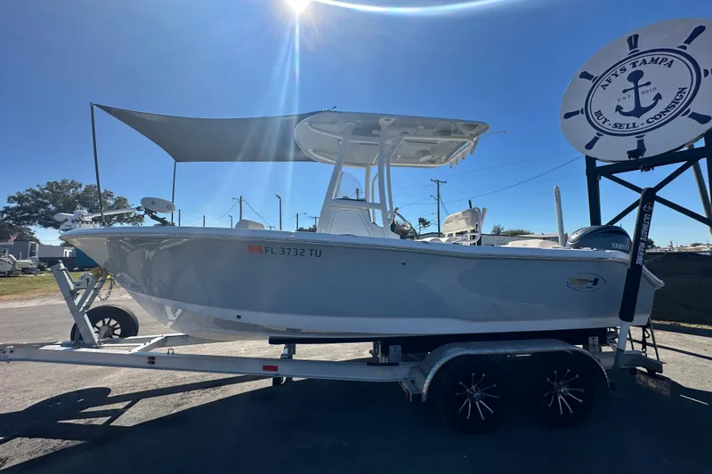 Slide: The Image of 2024 Sea Hunt Ultra 219 boat on trailer under sunny sky. - 102