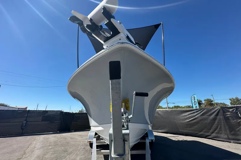 Slide: The Image of 2024 Sea Hunt Ultra 219 boat on trailer under clear blue sky. - 104