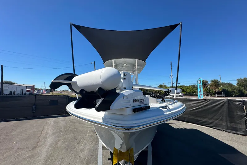 Slide: The Image of 2024 Sea Hunt Ultra 219 boat with Minn Kota Terrova motor, displayed outdoors. - 105