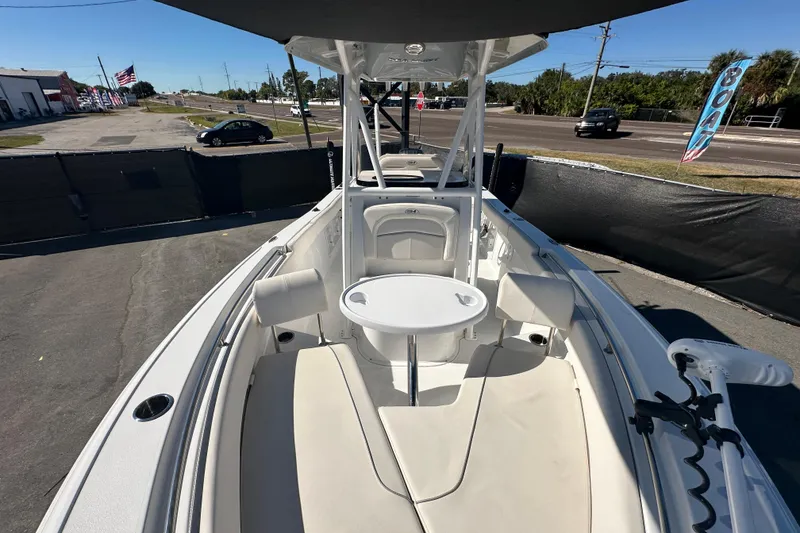 Slide: The Image of 2024 Sea Hunt Ultra 219 boat with seating and table, displayed outdoors. - 108