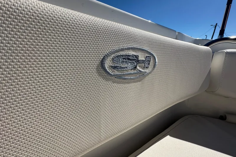 Slide: The Image of 2024 Sea Hunt Ultra 219 boat interior with SH logo on textured upholstery. - 110