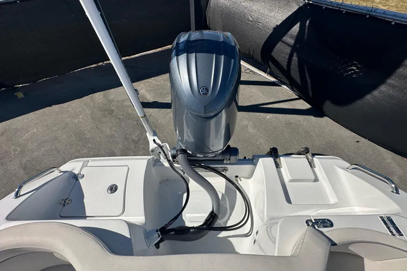 Slide: The Image of 2024 Sea Hunt Ultra 219 boat with outboard motor and seating area. - 13