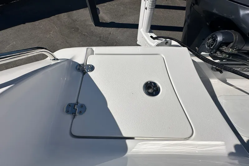 Slide: The Image of 2024 Sea Hunt Ultra 219 boat deck with storage compartment and latch. - 14