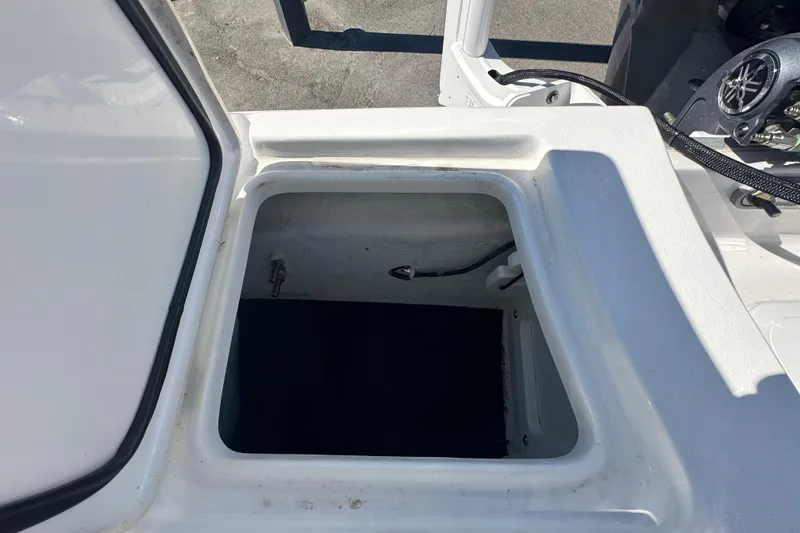Slide: The Image of Open storage compartment on 2024 Sea Hunt Ultra 219 boat. - 15
