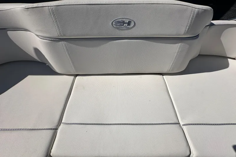 Slide: The Image of 2024 Sea Hunt Ultra 219 boat seat with white upholstery and logo. - 18