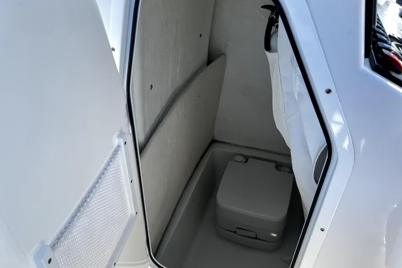 Slide: The Image of 2024 Sea Hunt Ultra 219 boat interior with compact storage compartment. - 2
