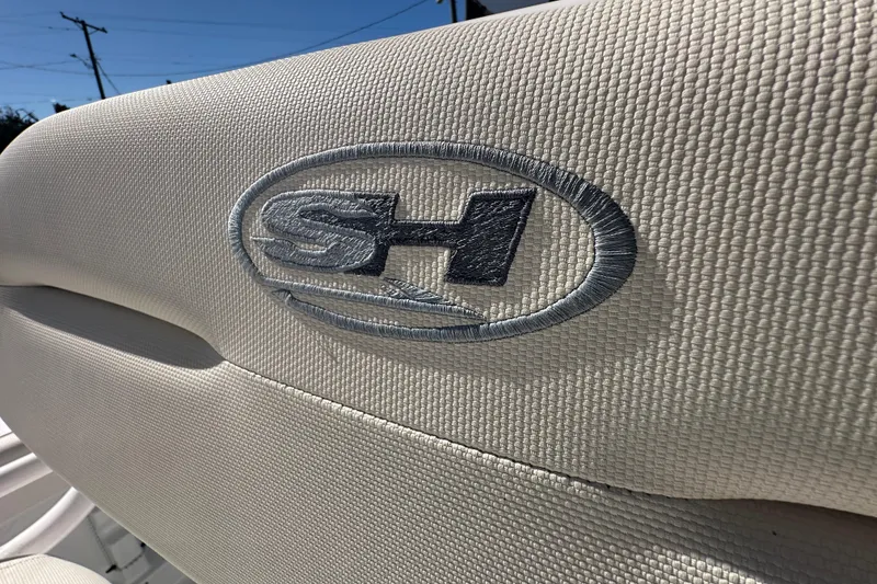 Slide: The Image of 2024 Sea Hunt Ultra 219 boat seat with embroidered logo in sunlight. - 21
