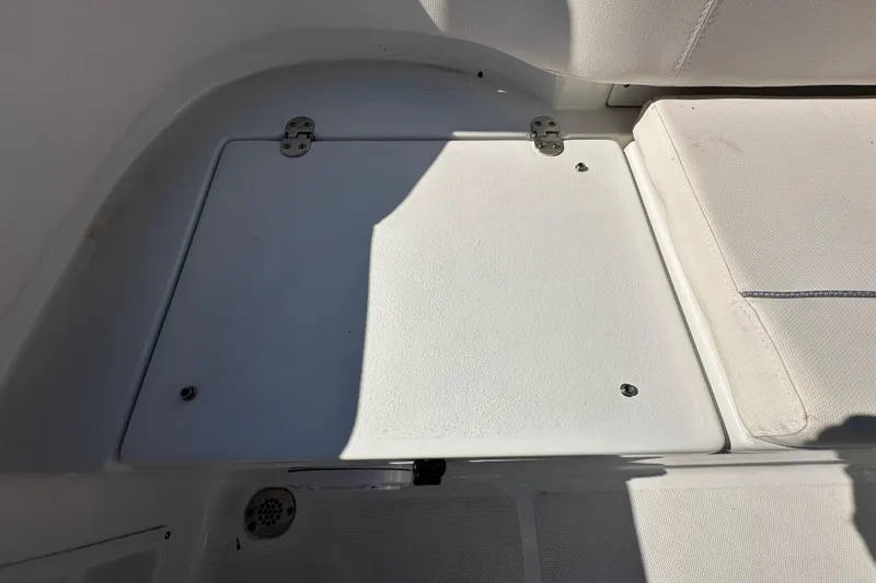 Slide: The Image of 2024 Sea Hunt Ultra 219 boat deck with storage compartment and seating. - 23