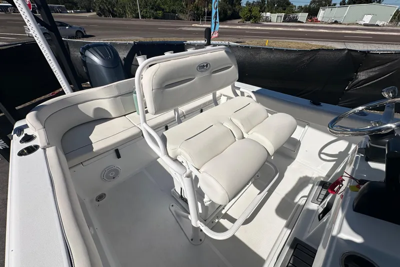 Slide: The Image of 2024 Sea Hunt Ultra 219 boat interior with white seating and steering wheel. - 26