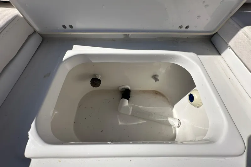 Slide: The Image of 2024 Sea Hunt Ultra 219 boat storage compartment, open and empty. - 27
