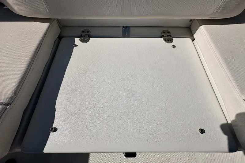 Slide: The Image of 2024 Sea Hunt Ultra 219 boat seat with storage compartment, featuring a closed lid. - 28