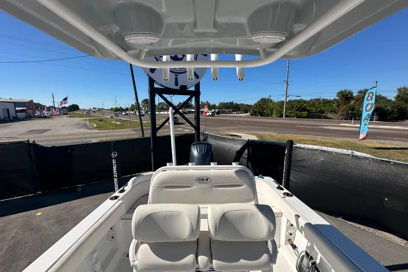 Slide: The Image of 2024 Sea Hunt Ultra 219 boat interior with seating and console, displayed outdoors. - 29