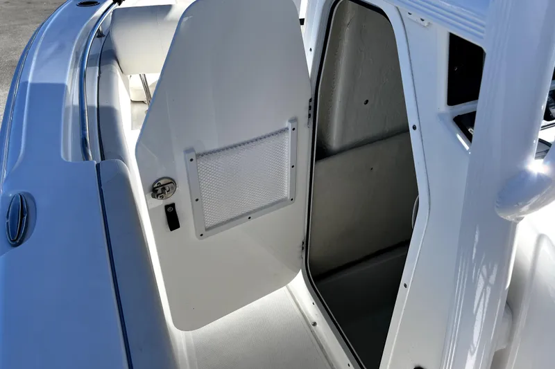 Slide: The Image of 2024 Sea Hunt Ultra 219 boat interior with open storage compartment door. - 3