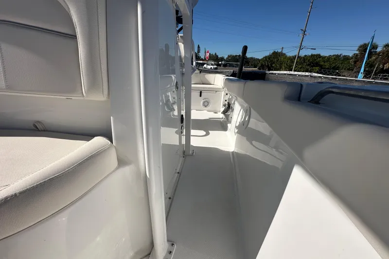 Slide: The Image of 2024 Sea Hunt Ultra 219 boat interior, showcasing sleek white seating and deck design. - 34