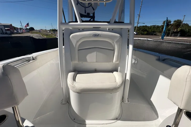 Slide: The Image of 2024 Sea Hunt Ultra 219 boat interior with white seating and console. - 36