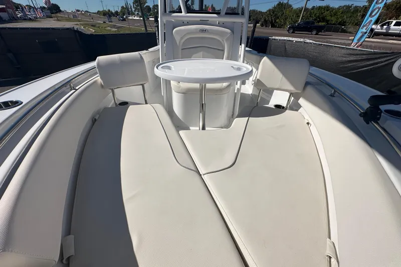 Slide: The Image of 2024 Sea Hunt Ultra 219 boat interior with cushioned seating and table. - 38