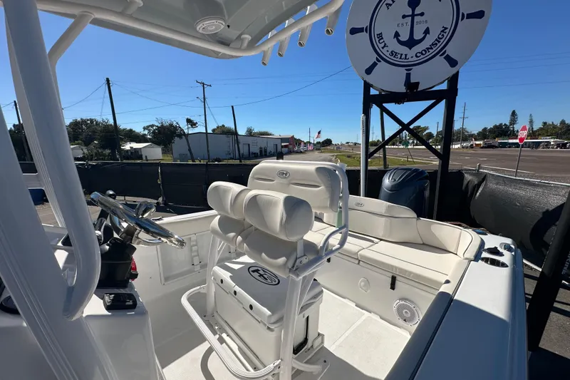 Slide: The Image of 2024 Sea Hunt Ultra 219 boat interior with seating and steering wheel, displayed outdoors. - 43