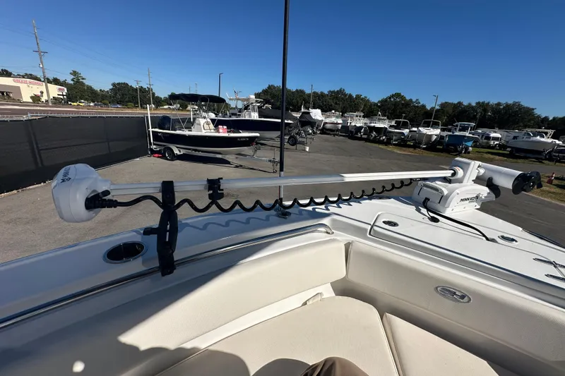 Slide: The Image of 2024 Sea Hunt Ultra 219 boat with Minn Kota trolling motor in a marina setting. - 46