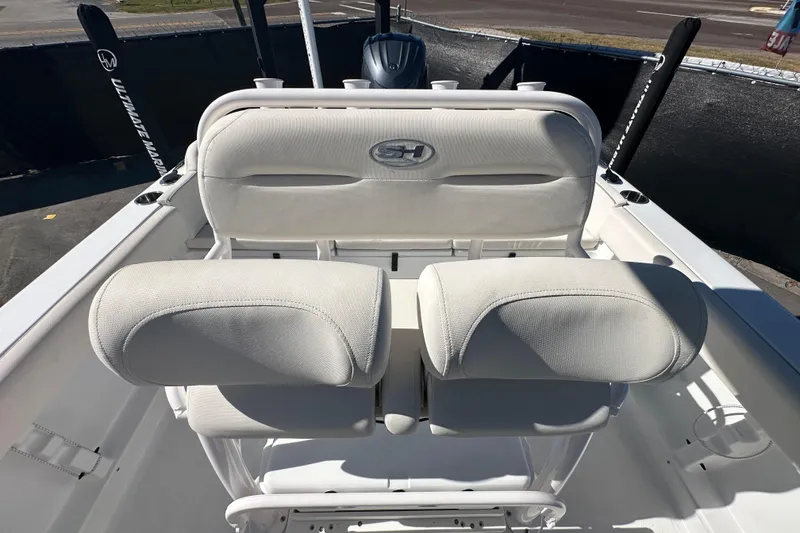 Slide: The Image of 2024 Sea Hunt Ultra 219 boat seating with white upholstery and logo. - 47