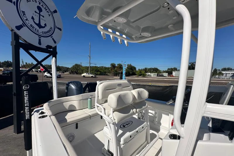 Slide: The Image of 2024 Sea Hunt Ultra 219 boat interior with seating and console, displayed outdoors. - 48