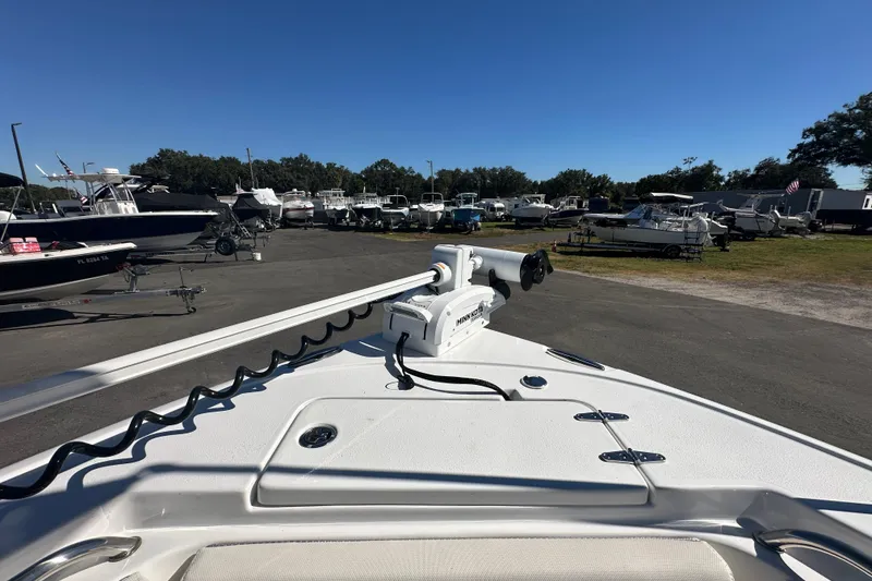 Slide: The Image of 2024 Sea Hunt Ultra 219 boat at a marina with other vessels. - 51