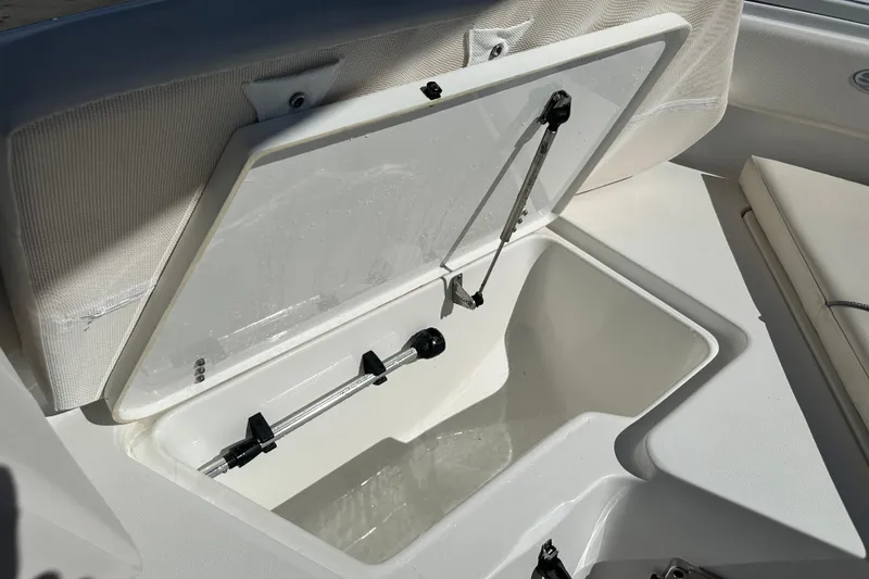 Slide: The Image of 2024 Sea Hunt Ultra 219 boat storage compartment with open lid and hydraulic support. - 53