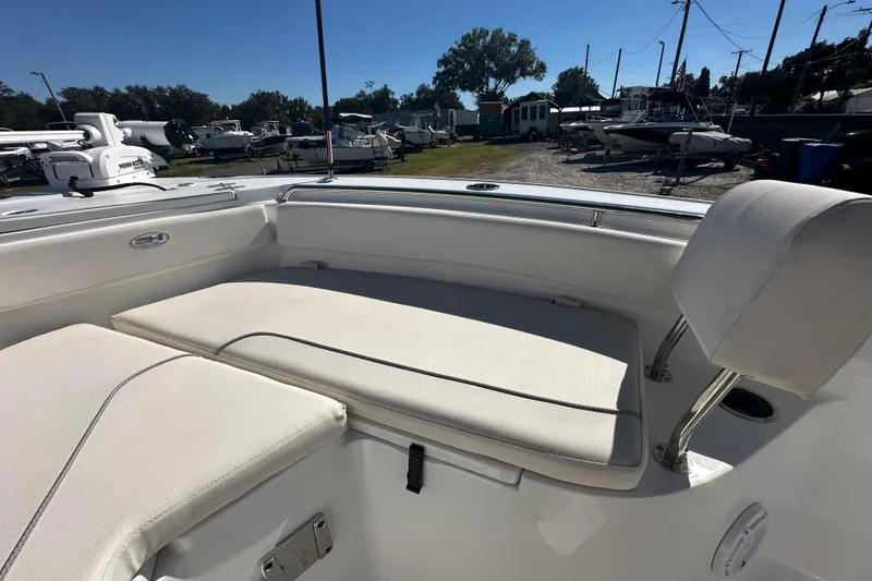 Slide: The Image of 2024 Sea Hunt Ultra 219 boat interior with cushioned seating and sleek design. - 54