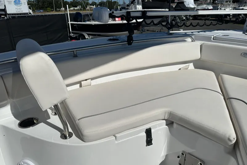 Slide: The Image of 2024 Sea Hunt Ultra 219 boat interior with white cushioned seating. - 55