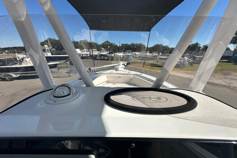 Slide: The Image of 2024 Sea Hunt Ultra 219 boat interior with compass and windshield view. - 59