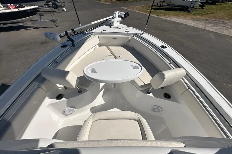 Slide: The Image of 2024 Sea Hunt Ultra 219 boat interior with seating and table setup. - 60