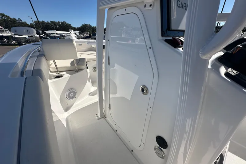 Slide: The Image of 2024 Sea Hunt Ultra 219 boat interior with seating and storage compartment. - 65