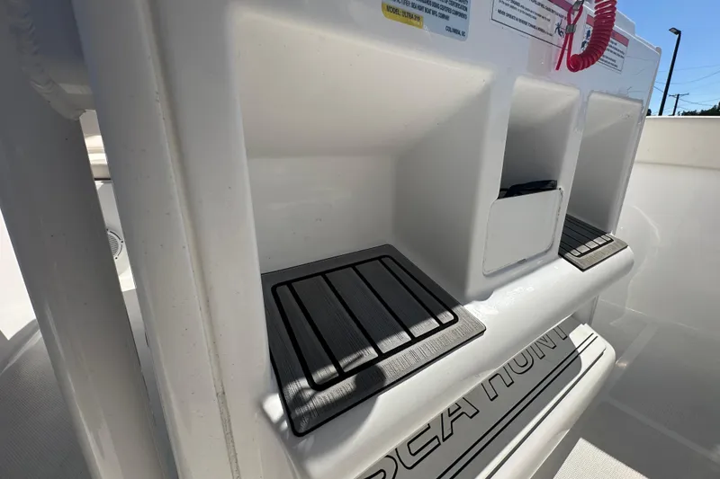 Slide: The Image of 2024 Sea Hunt Ultra 219 boat interior with storage compartments and non-slip mats. - 68