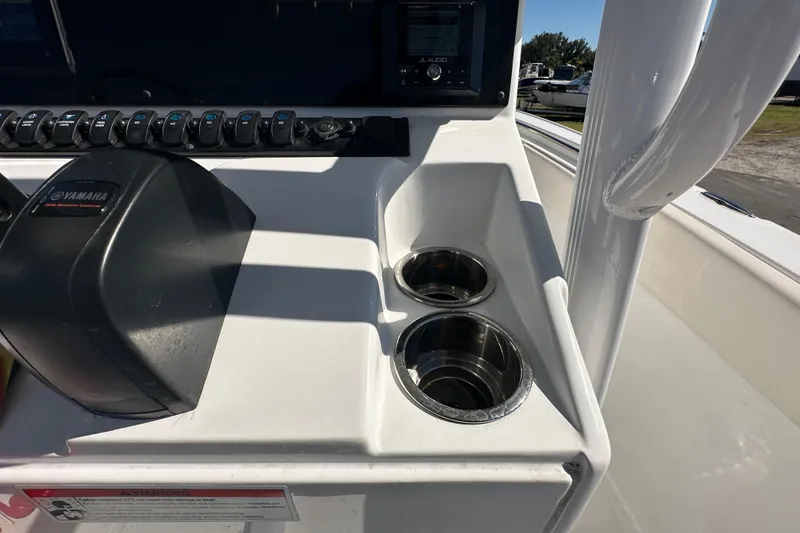Slide: The Image of 2024 Sea Hunt Ultra 219 boat console with Yamaha controls and cup holders. - 69