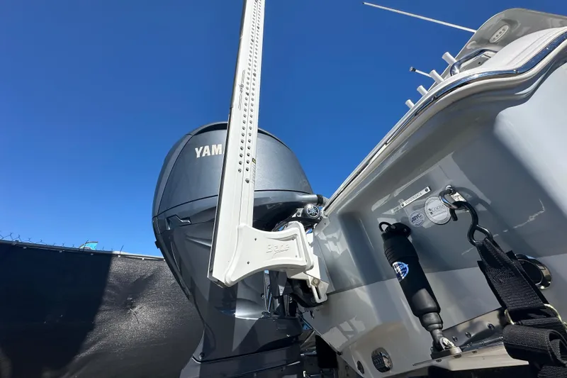 Slide: The Image of 2024 Sea Hunt Ultra 219 boat with Yamaha outboard motor under clear blue sky. - 7