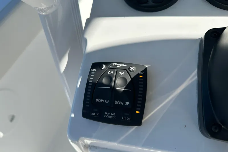 Slide: The Image of 2024 Sea Hunt Ultra 219 trim tab control panel on boat dashboard. - 71