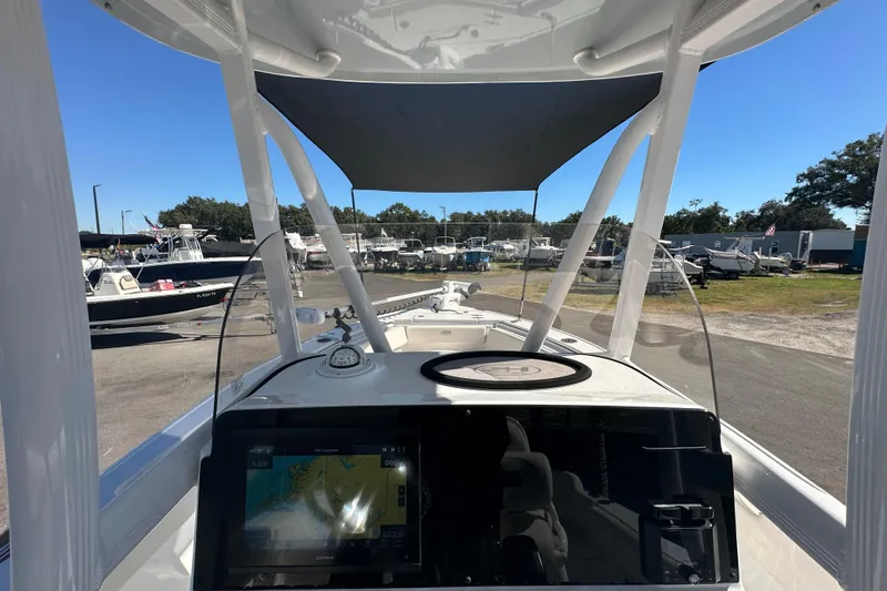Slide: The Image of 2024 Sea Hunt Ultra 219 boat dashboard with navigation system and canopy. - 82