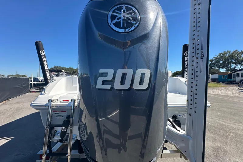 Slide: The Image of 2024 Sea Hunt Ultra 219 boat with 200 horsepower engine, parked outdoors. - 98